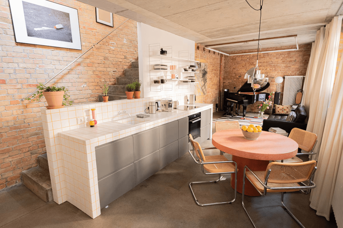Sleek modern kitchen island inside an old brick factory space